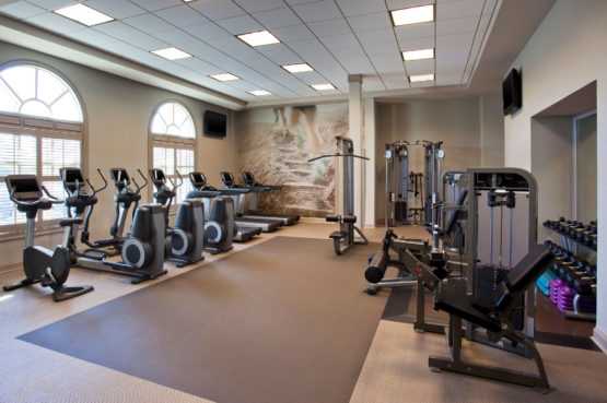 the fitness room equipped with treadmills, weights and bicycles