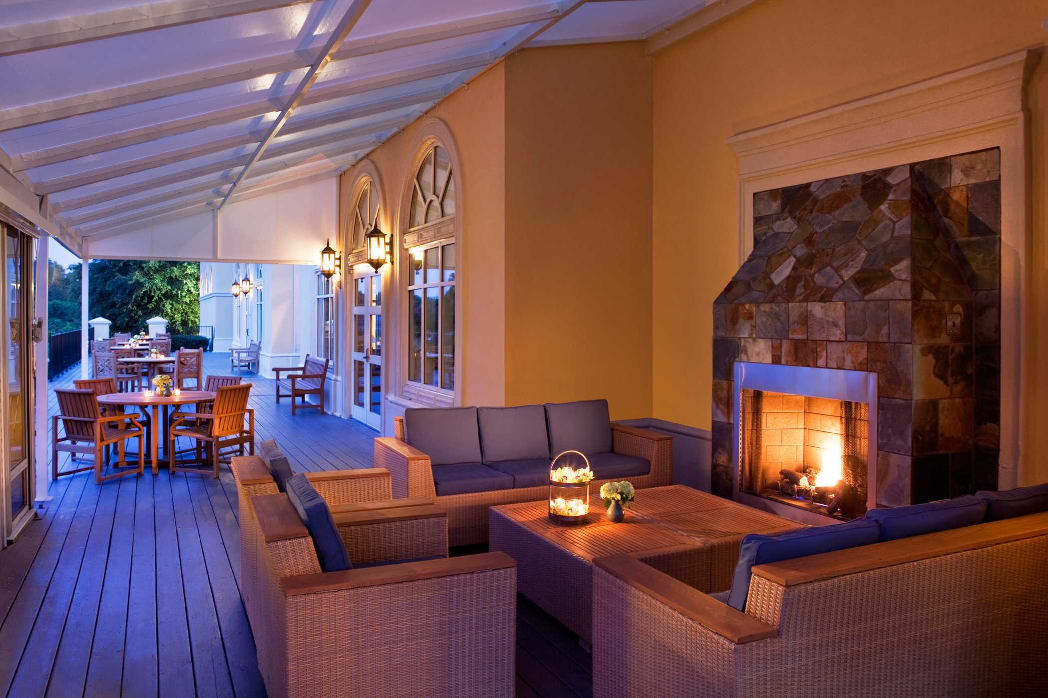 outdoor patio couches in front of the lit fireplace
